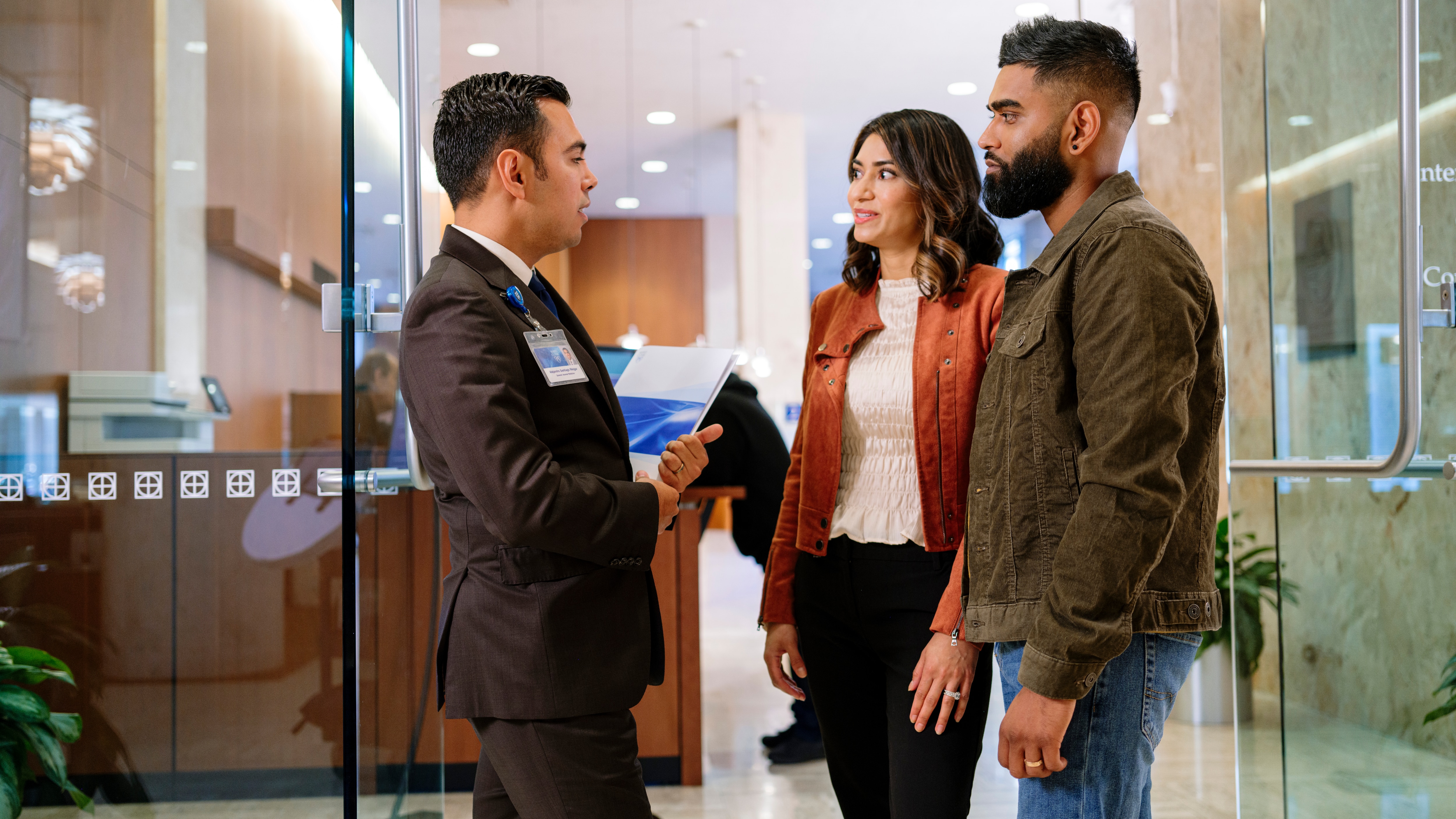 Mayo Clinic representative greeting patients and providing arrival guidance in the lobby. 